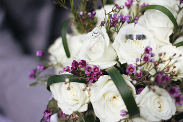 Wedding Rings on a White and Purple Bridal Bouquet