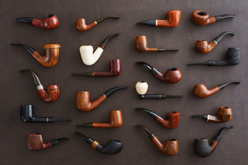 Collection of pipes on brown faux leather