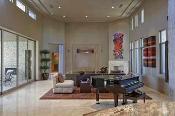 View of a luxury and spacious living room with piano in foreground at house