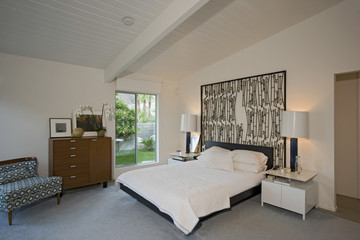 View of two lamps by bed in spacious bedroom