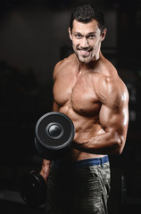 Naklejka na ściany i meble man with weight training in gym equipment sport club
