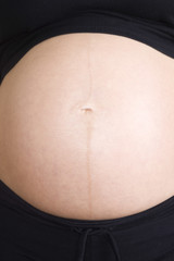 Detail shot of a pregnant woman's tummy