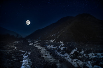 Fototapeta premium full moon over mountain and river snowy landscape in Azerbaijan winter night