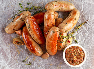 Home-made Pork Sausages on crumpled paper with thyme
