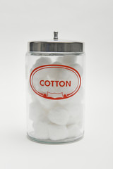 A glass bottle with cotton isolated over white background