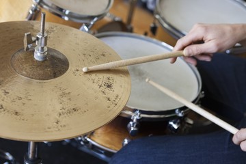 Fototapeta na wymiar Closeup of hands playing drum set