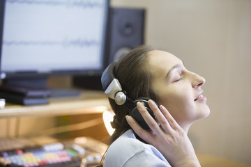 Closeup side view of a female sound engineer enjoying to music - Powered by Adobe