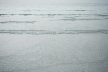 Tiny ripples in Arabian Gulf on public beach in Jumeirah, Dubai, UAE