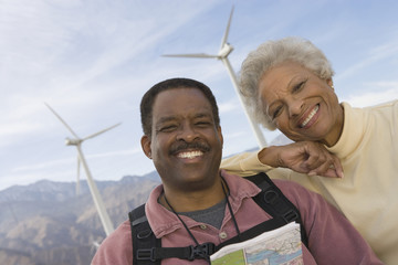 Portrait of happy mature African American couple at wind farm