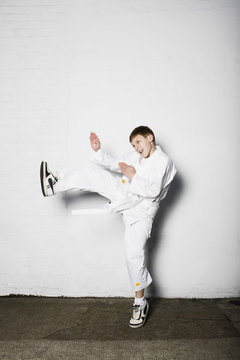 Full length of a young boy practicing judo