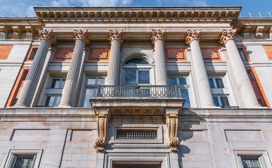 Fototapeta premium European architecture building details with Corinthian Capital columns. European style from decades past combined with updated glass features reflected in doors and windows. 