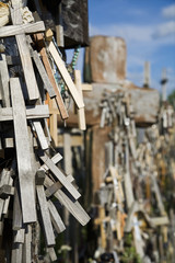 Wooden crosses hanging on tombstone at Lithuanian graveyard