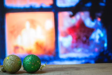 Multicolored Christmas ornaments on the window