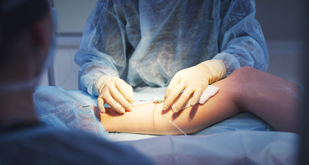 doctor and an assistant in operating room for surgical venous va