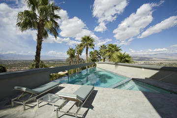 View of swimming pool against landscape and cloudy sky