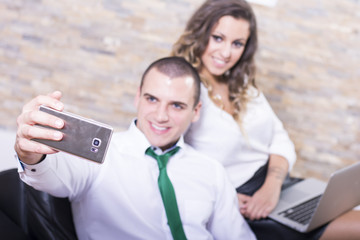 Happy smiling couple in love take self portrait while on a break.