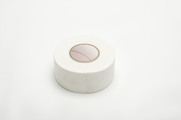 Roll of medical sticking plaster isolated over white background
