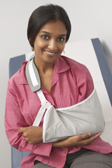 Portrait of a smiling Indian female with arm in sling