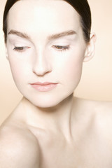 Fototapeta premium Closeup of a young woman with fresh skin against colored background