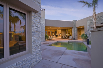 View of swimming pool in front of a modern house against sky