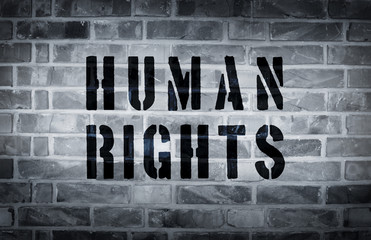 Human rights stencil print on the grunge white brick wall