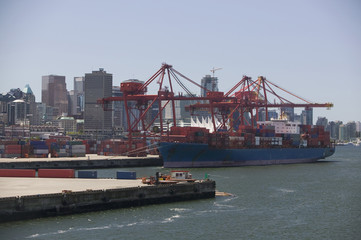 Cargo ship in Vancouver Harbour British Columbia with buildings in background