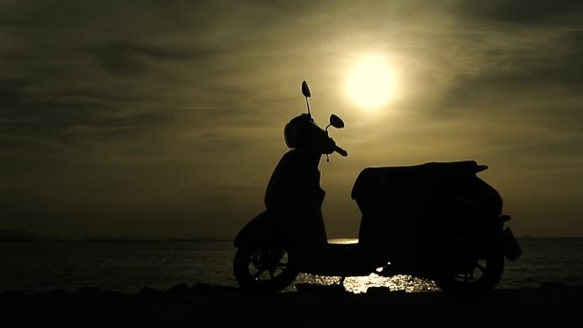 Silhouette motorcycle parking at seaside, Handheld shot