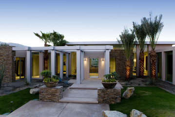 Obraz premium Lawn and walkway in front of a modern house against clear sky