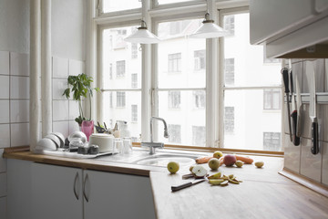 Kitchen worktop with chopped fruit and vegetables in urban apartment