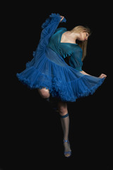 Full length of a woman dancing against black background