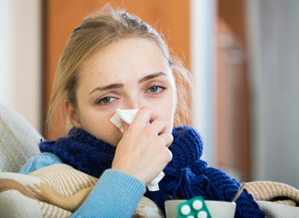 Young woman suffering of cold and having stuffy nose