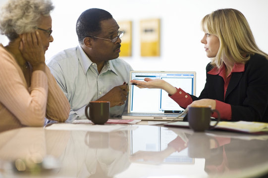 Financial Advisor Assisting An African American Couple At Home