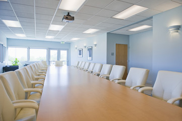 Empty chairs around table in a conference room