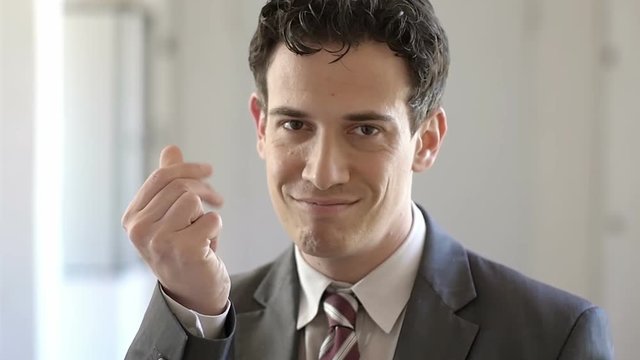 Money: a Bisnessman indicates the money with his fingers, the cash, grain, grit