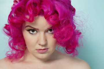 Portrait of a pink hair woman over colored background