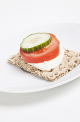Crispbread with tomato and cucumber slice and cheese