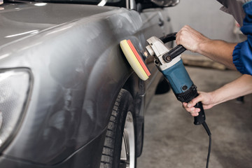 man polishing cleaning car with microfiber cloth, detailing or valeting concept