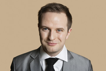 Portrait of young businessman over colored background