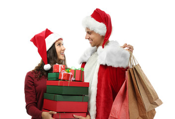 Young couple with Christmas purchases on white background