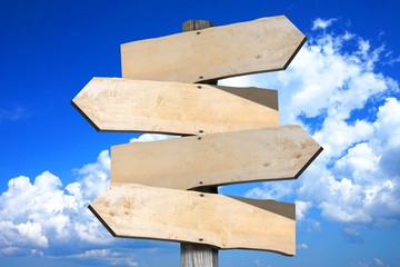 Empty wooden signpost - four arrows
