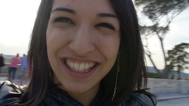 smiling woman portrait: young woman turns around and smiles