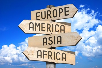 Wooden signpost with four arrows - Europe, America, Asia, Africa - great for topics like continents, traveling etc. 