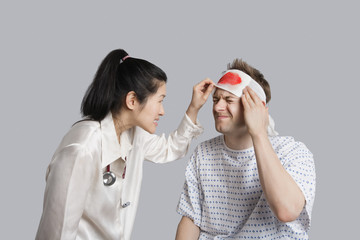 Patient suffering from pain while doctor examining him