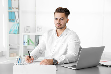 Fototapeta premium Handsome man working in office