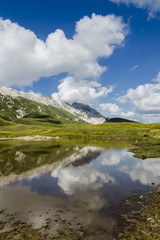 Fototapeta na wymiar Panoramic view of beautiful landscape with Gran Sasso d'Italia peak at Campo Imperatore plateau in the Apennine Mountains, Abruzzo, Italy