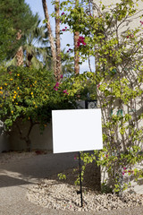 Real estate sign board outside house