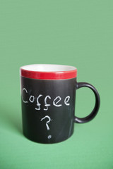 Close-up of coffee cup with text over colored background