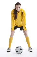 Fototapeta na wymiar Portrait of young woman with soccer ball against white background