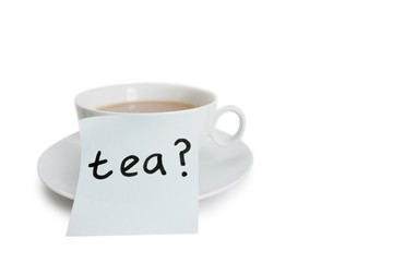 Close-up of sticky notepaper with teacup over white background