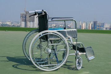 wheelchair the background is a building 